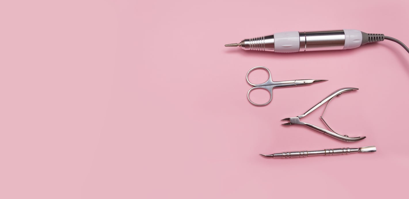 Banner nail care. Cutters for hardware manicure. Accessories and nail tool on pink background. Milling cutter for manicure